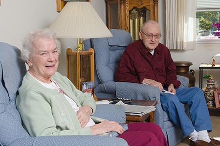 Seniors sitting in chairs at home